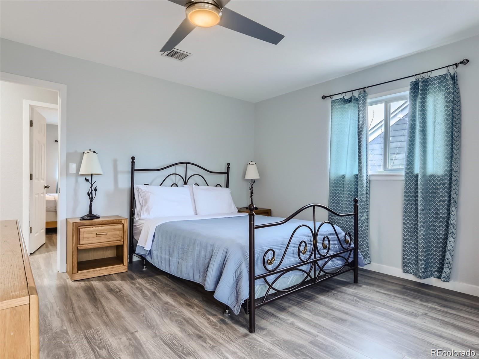 5941 South Perth Street Centennial, CO 80015 - Photo 15 of 28 a bedroom with a bed and a window