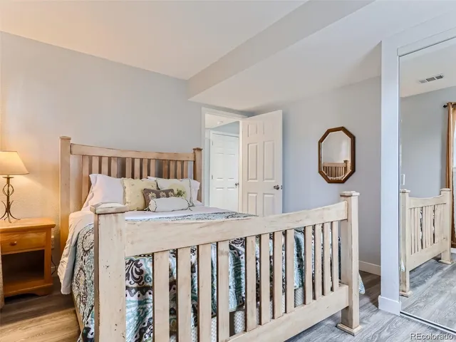 a bedroom with a bed and a mirror