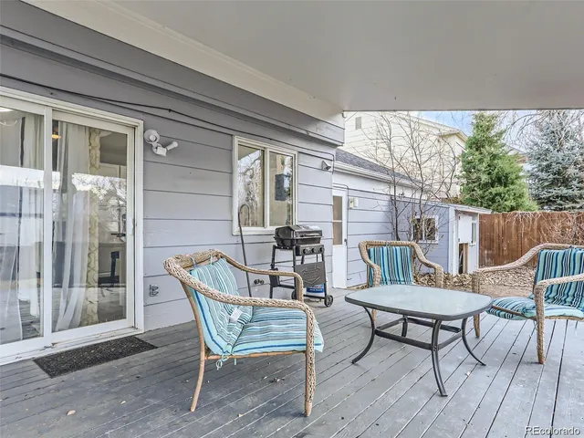 a view of a patio with table and chairs and wooden floor