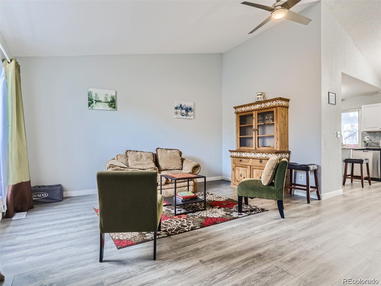 5941 South Perth Street Centennial, CO 80015 - Photo 4 of 28 a living room with furniture and a wooden floor