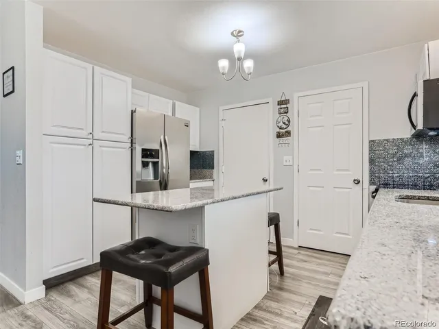 a kitchen with stainless steel appliances a refrigerator and a stove top oven