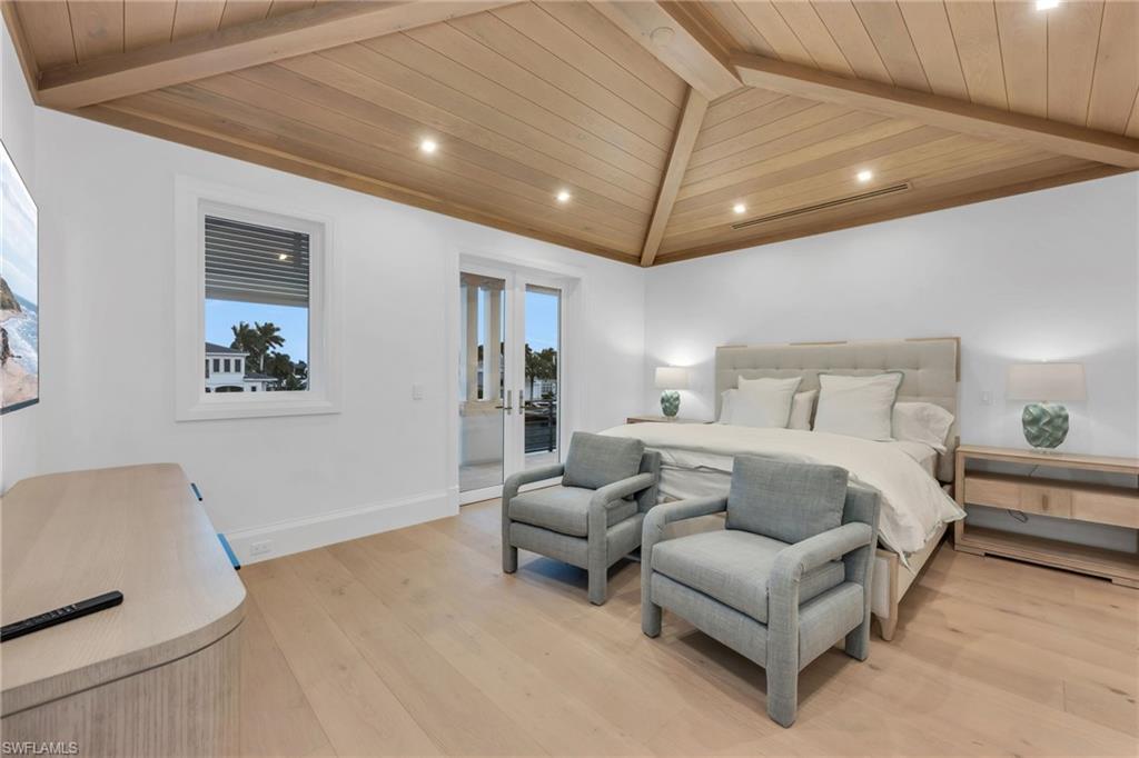 1935 5th Street South Naples, FL 34102 - Photo 31 of 40 a spacious bedroom with a bed and furniture