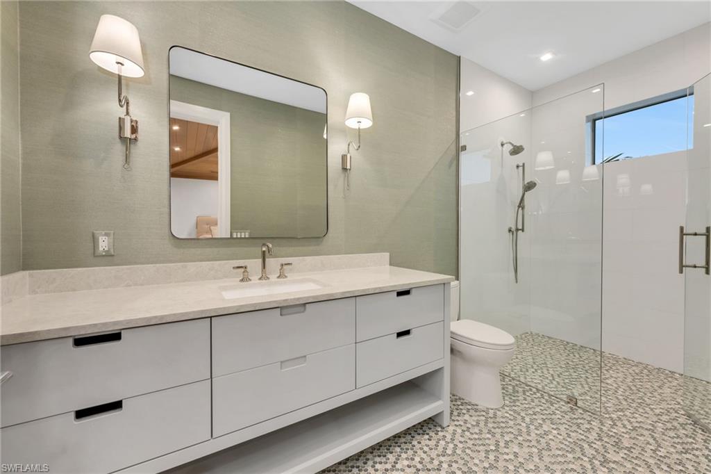 1935 5th Street South Naples, FL 34102 - Photo 32 of 40 a bathroom with a sink a toilet and shower