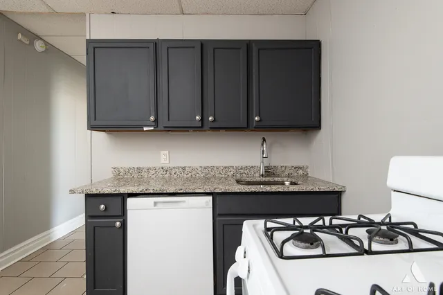 a kitchen with a sink and a stove top oven