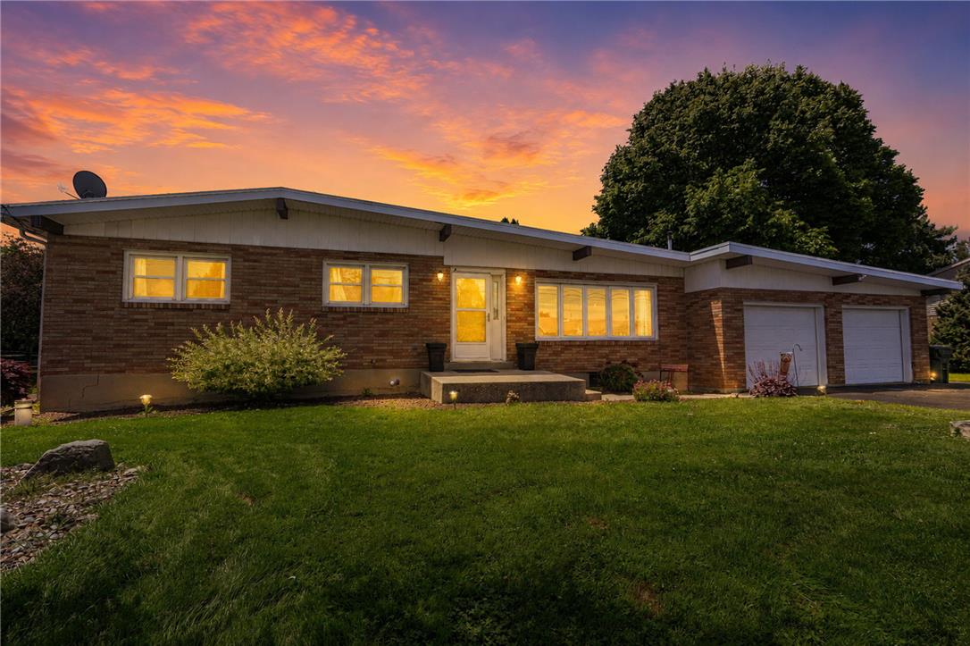 579 Cherry Road Northampton, PA 18067 - Photo 57 of 57 A classic brick exterior under a vivid sunset, offering a warm welcome with its inviting front entry.