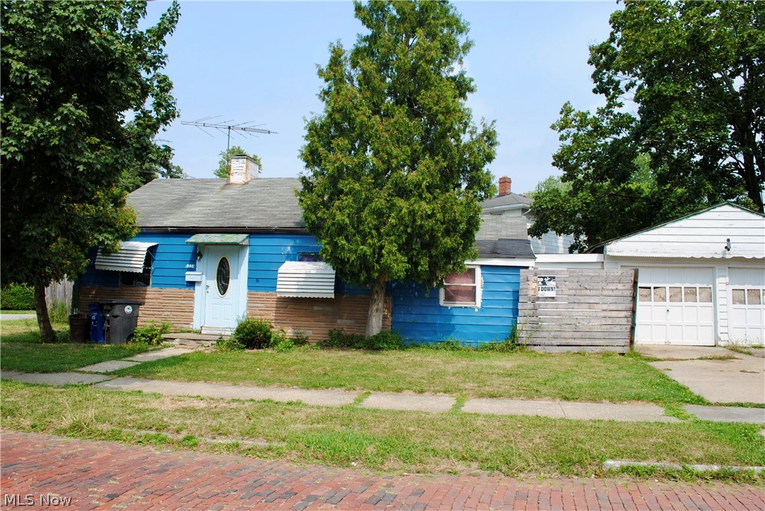 3775 Highland Road Cleveland, OH 44111 - Photo 1 of 11 Blue siding exterior with a brick foundation and a two-car detached garage