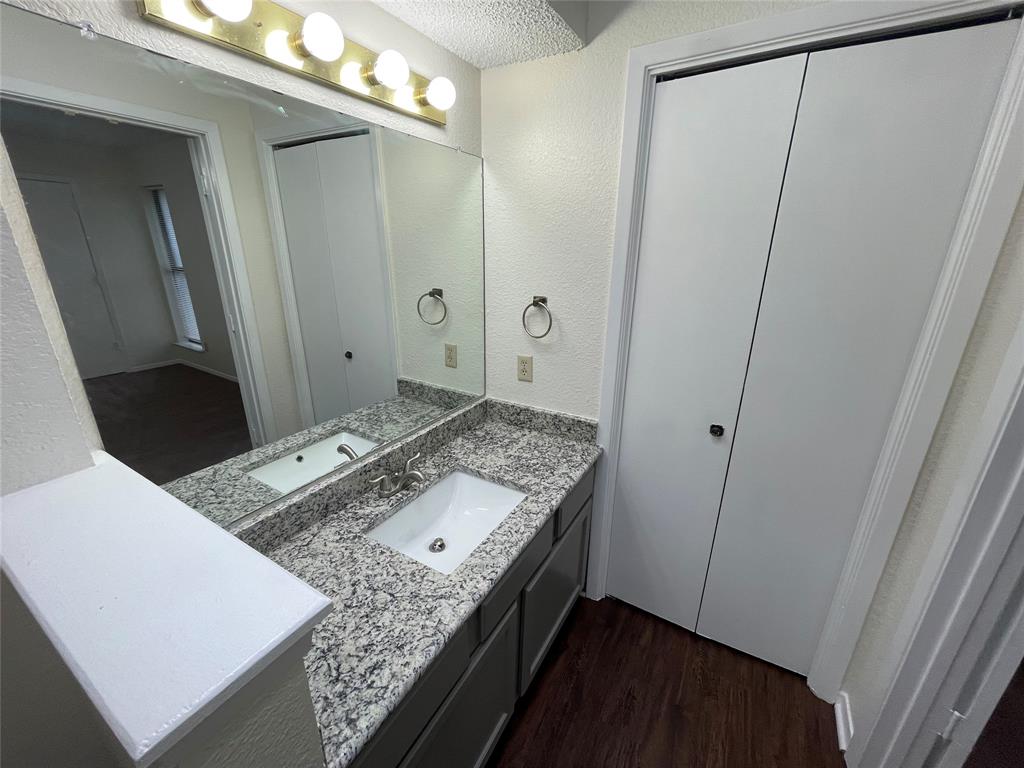 2510 Stanford Street, Unit A Rowlett, TX 75088 - Photo 11 of 11 a bathroom with a granite countertop sink and a mirror
