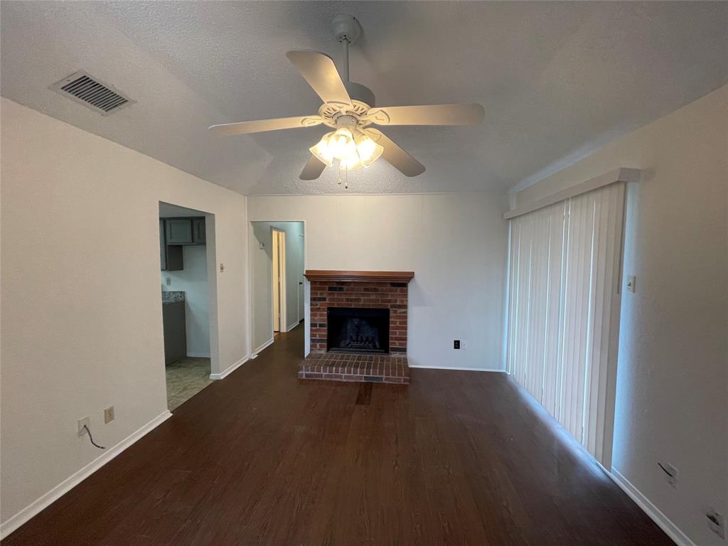 2510 Stanford Street, Unit A Rowlett, TX 75088 - Photo 3 of 11 a view of an empty room with chandelier fan and fire place
