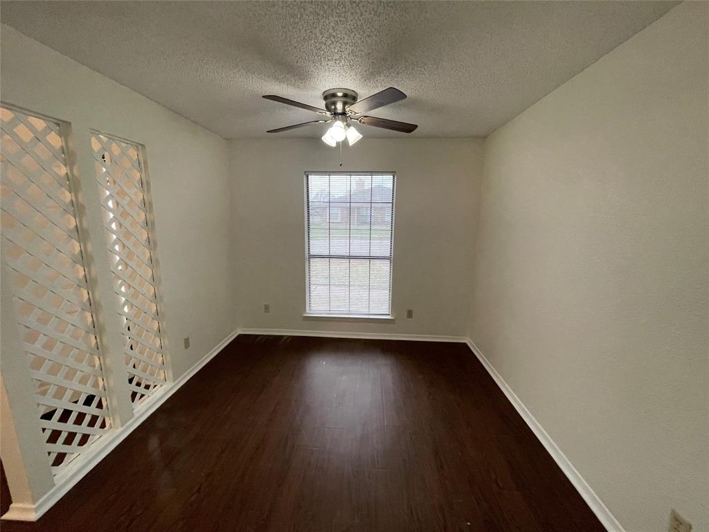 2510 Stanford Street, Unit A Rowlett, TX 75088 - Photo 5 of 11 a view of an empty room with wooden floor and a window