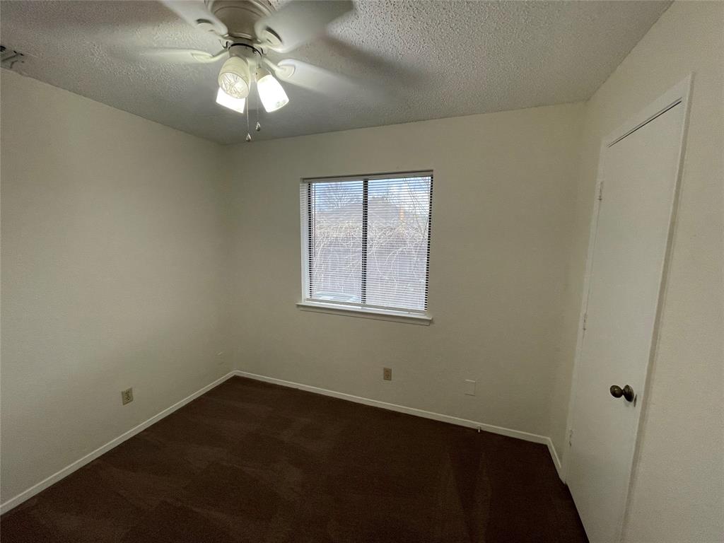 2510 Stanford Street, Unit A Rowlett, TX 75088 - Photo 7 of 11 an empty room with a window and a fan