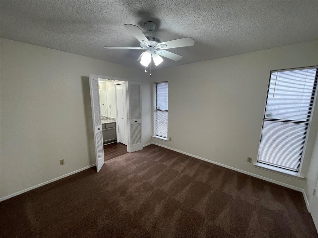 2510 Stanford Street, Unit A Rowlett, TX 75088 - Photo 9 of 11 an empty room with closet and windows