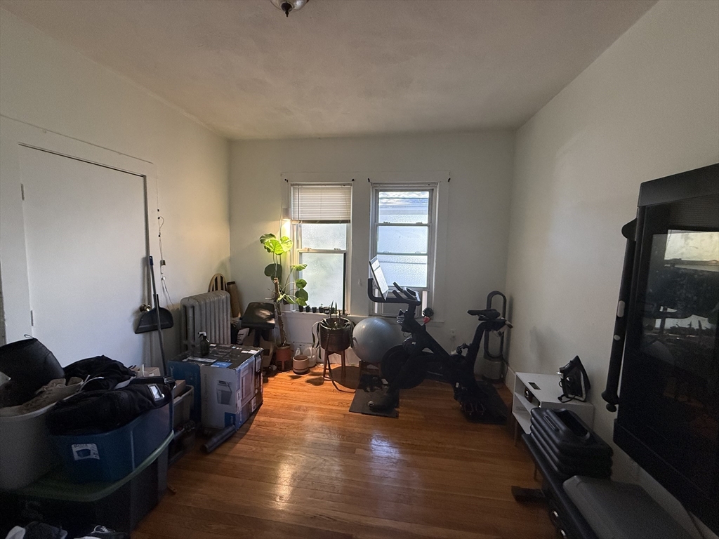 107 Bloomfield Street, Unit 3 Boston, MA 02124 - Photo 12 of 14 a living room with furniture and wooden floor