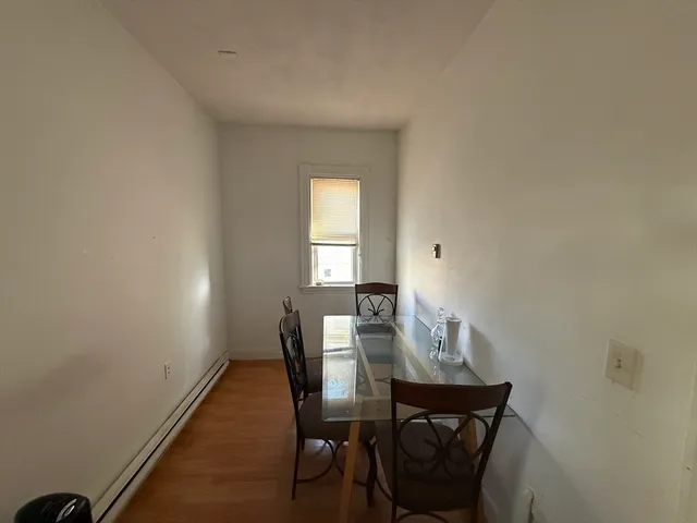 a view of a dining room with furniture and window