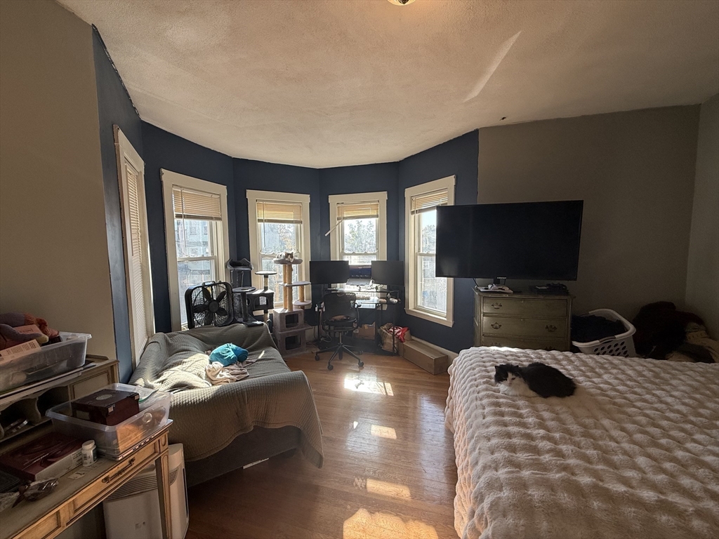 107 Bloomfield Street, Unit 3 Boston, MA 02124 - Photo 3 of 14 a bedroom with furniture and a flat screen tv