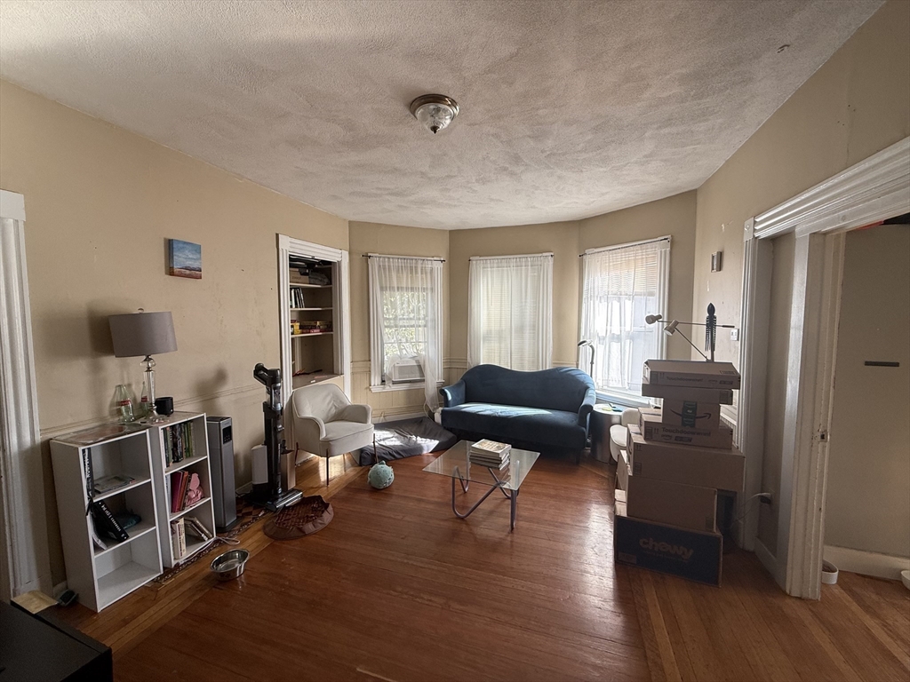 107 Bloomfield Street, Unit 3 Boston, MA 02124 - Photo 5 of 14 a living room with furniture and wooden floor