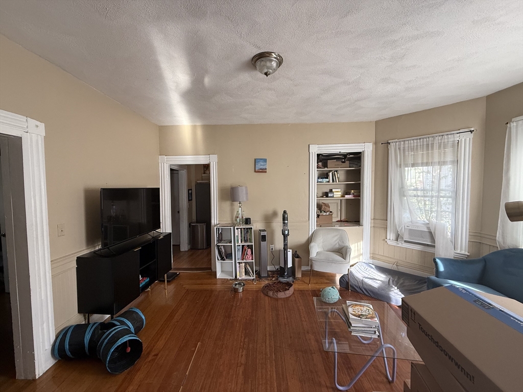 107 Bloomfield Street, Unit 3 Boston, MA 02124 - Photo 7 of 14 a living room with furniture and a flat screen tv