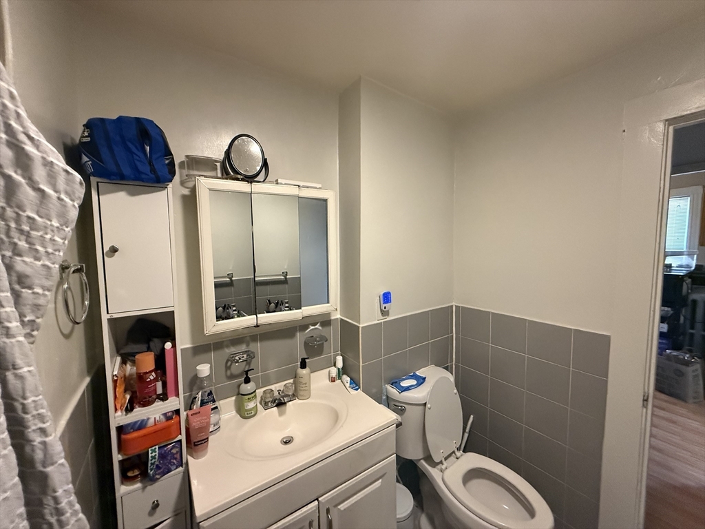 107 Bloomfield Street, Unit 3 Boston, MA 02124 - Photo 9 of 14 a bathroom with a sink toilet and shower