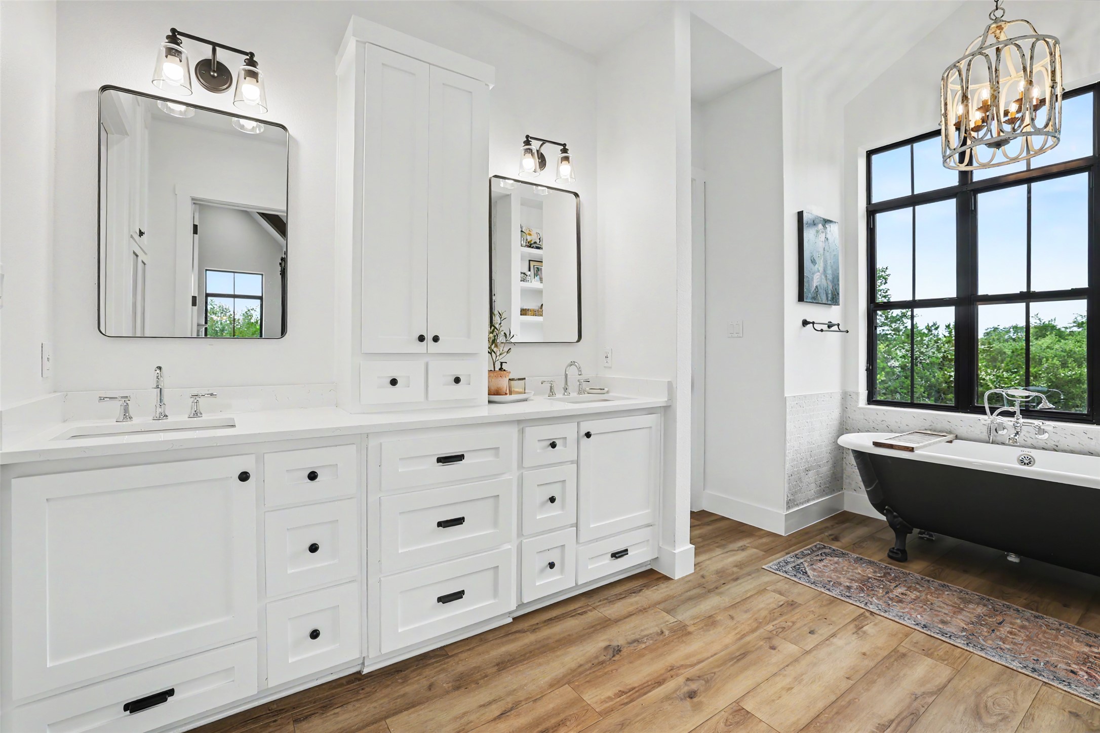 7670 Shiny Top Ranch Lane Salado, TX 76571 - Photo 22 of 40 a bathroom with double vanity sink a two mirror a window a bathtub and vanity