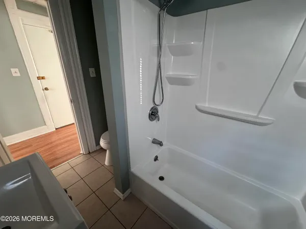 a view of a room with wooden floor and staircase