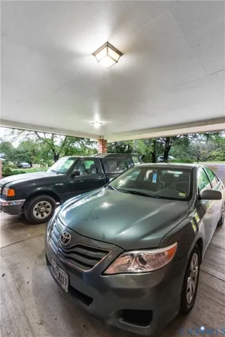 a view of a patio with table and chairs next to a yard