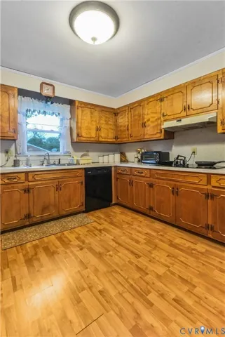 a large kitchen with granite countertop a sink and a stove