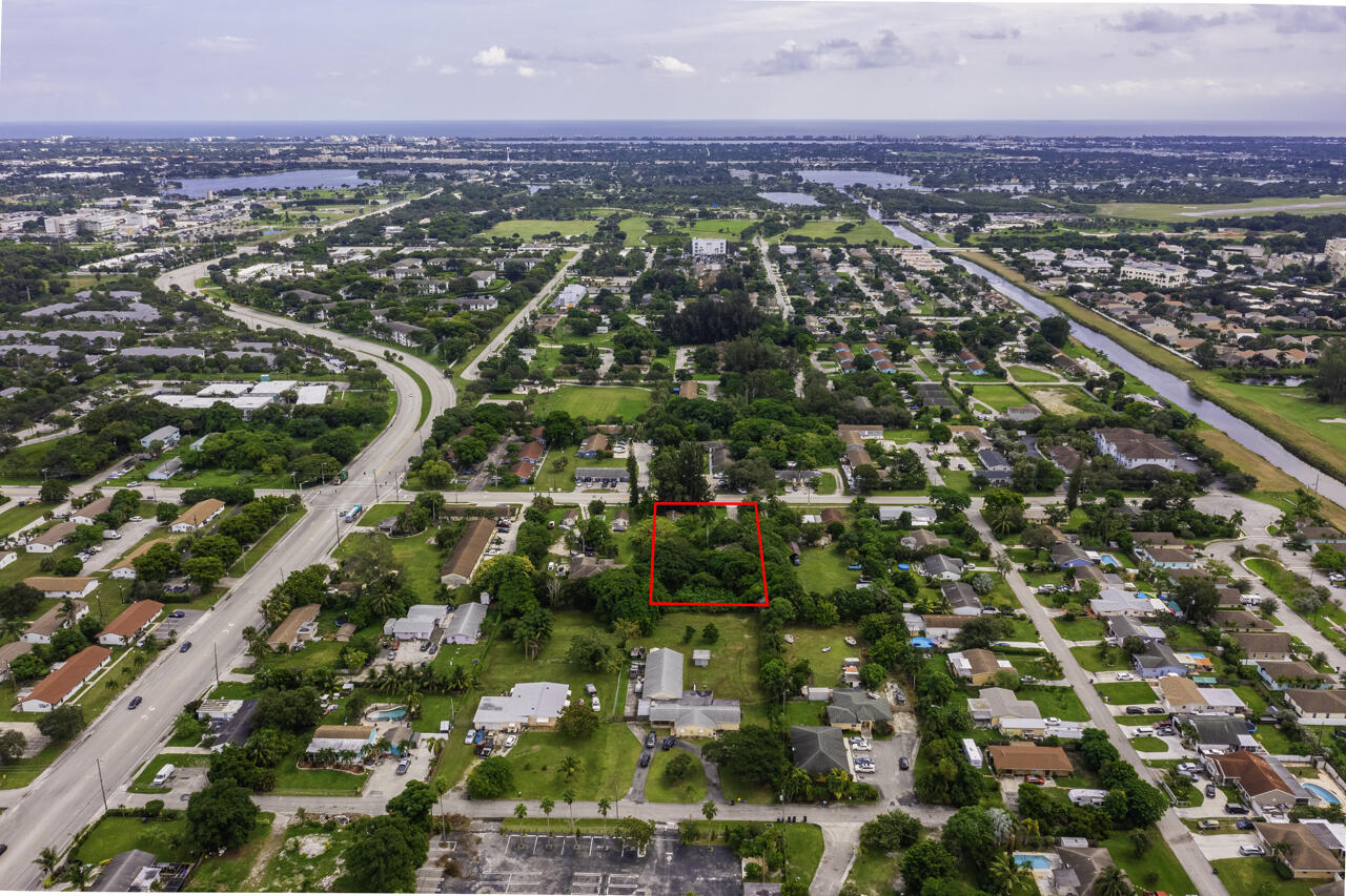 4843 Davis Road Lake Worth, FL 33461 - Photo 13 of 18 an aerial view of residential houses with outdoor space and trees
