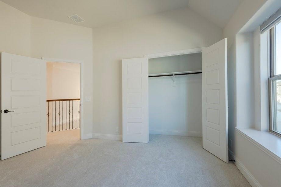 14561 Elion Court Pilot Point, TX 76258 - Photo 15 of 36 Unfurnished bedroom featuring light colored carpet, a closet, and vaulted ceiling