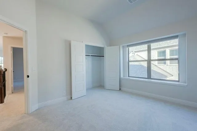 a view of a hallway with a window and stairs