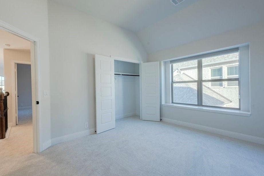 14561 Elion Court Pilot Point, TX 76258 - Photo 16 of 36 Unfurnished bedroom with carpet floors, lofted ceiling, and a closet