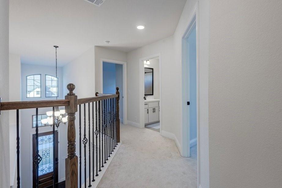 14561 Elion Court Pilot Point, TX 76258 - Photo 17 of 36 Corridor featuring a chandelier, light carpet, and recessed lighting