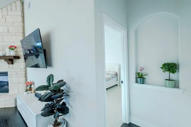 a living room with furniture fireplace and wooden floor