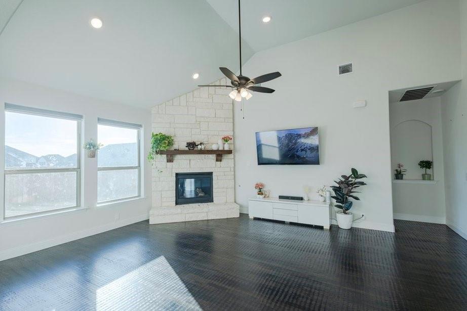 14561 Elion Court Pilot Point, TX 76258 - Photo 24 of 36 Living area featuring a fireplace, high vaulted ceiling, recessed lighting, and dark wood-type flooring