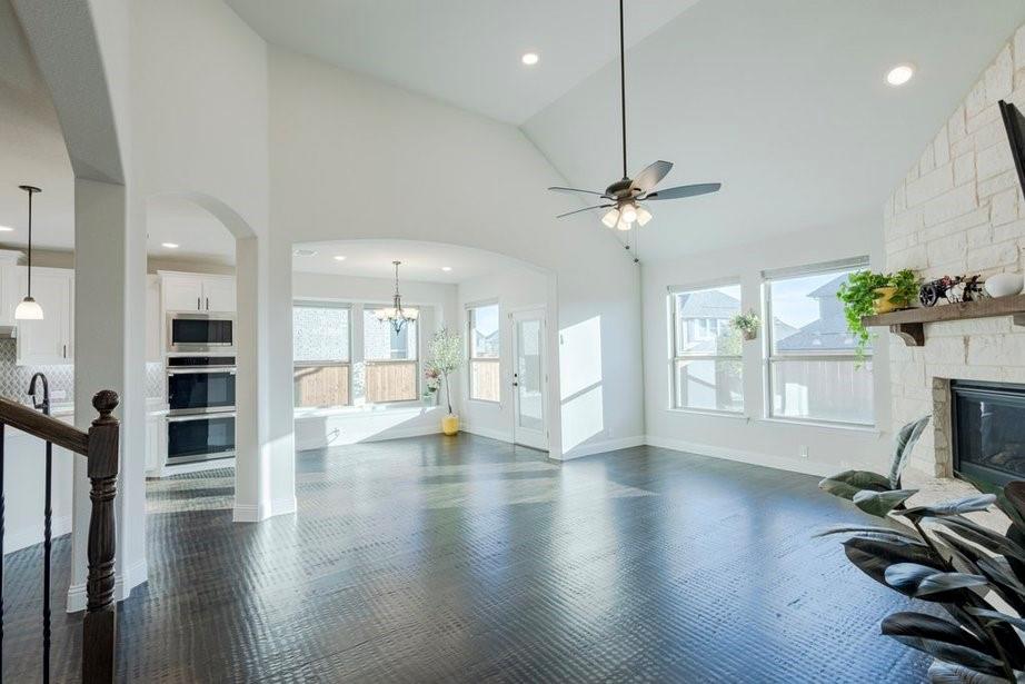 14561 Elion Court Pilot Point, TX 76258 - Photo 25 of 36 Unfurnished living room with plenty of natural light, arched walkways, high vaulted ceiling, recessed lighting, and a ceiling fan