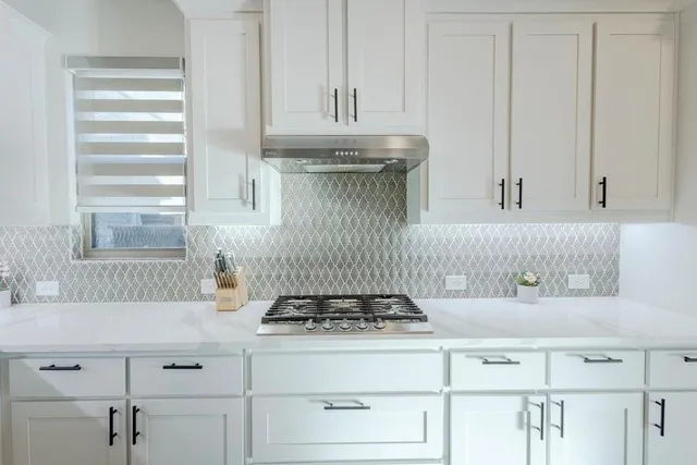 a kitchen with a stove and cabinets