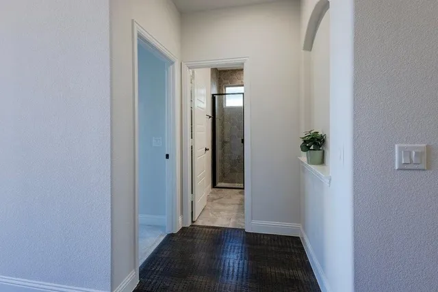 a view of a hallway with wooden floor