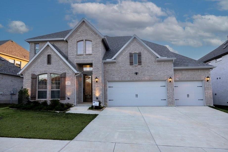14561 Elion Court Pilot Point, TX 76258 - Photo 4 of 36 French country inspired facade with brick siding, driveway, a front lawn, and roof with shingles