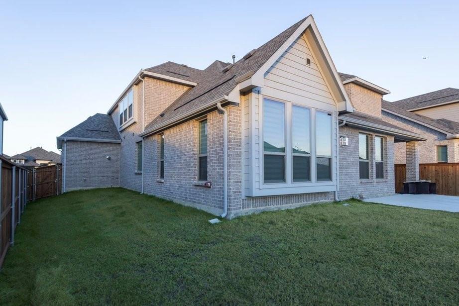 14561 Elion Court Pilot Point, TX 76258 - Photo 8 of 36 Rear view of property with a fenced backyard, brick siding, a patio area, and roof with shingles