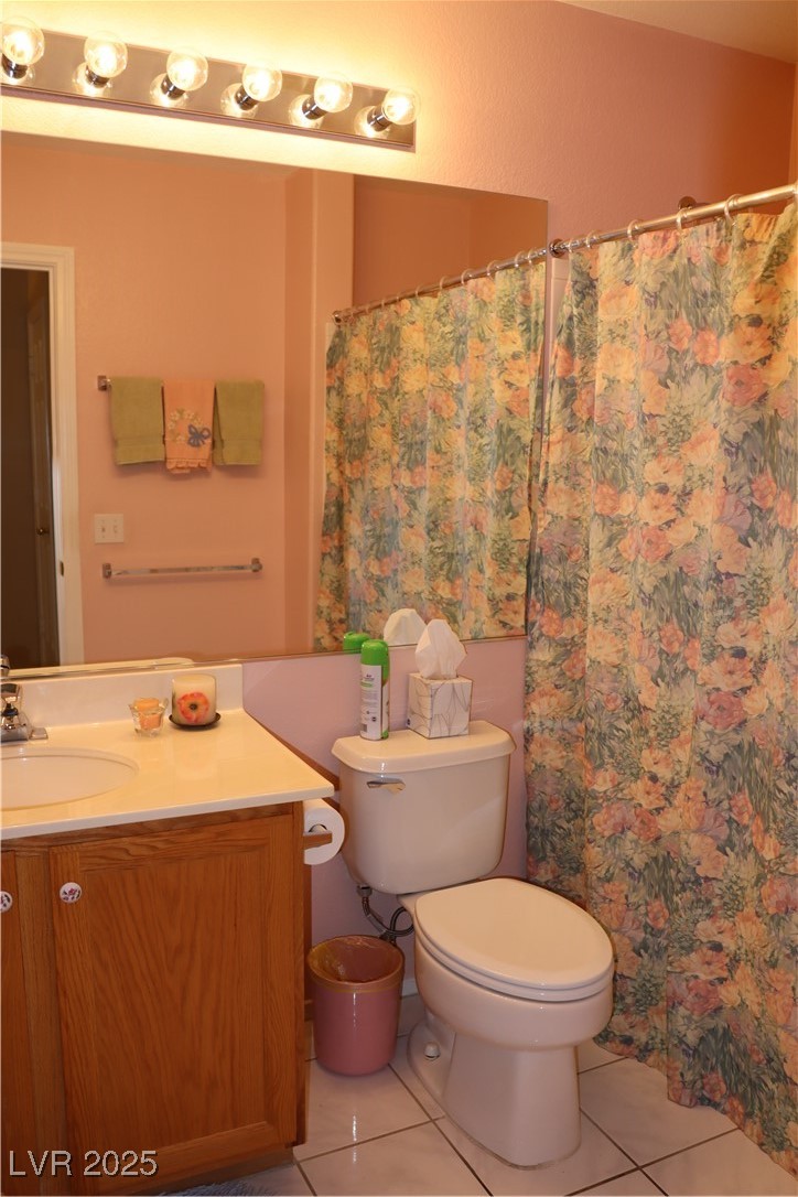 2148 Hidden Ranch Terrace Henderson, NV 89052 - Photo 29 of 31 Bathroom featuring toilet, a shower with curtain, tile patterned floors, and vanity