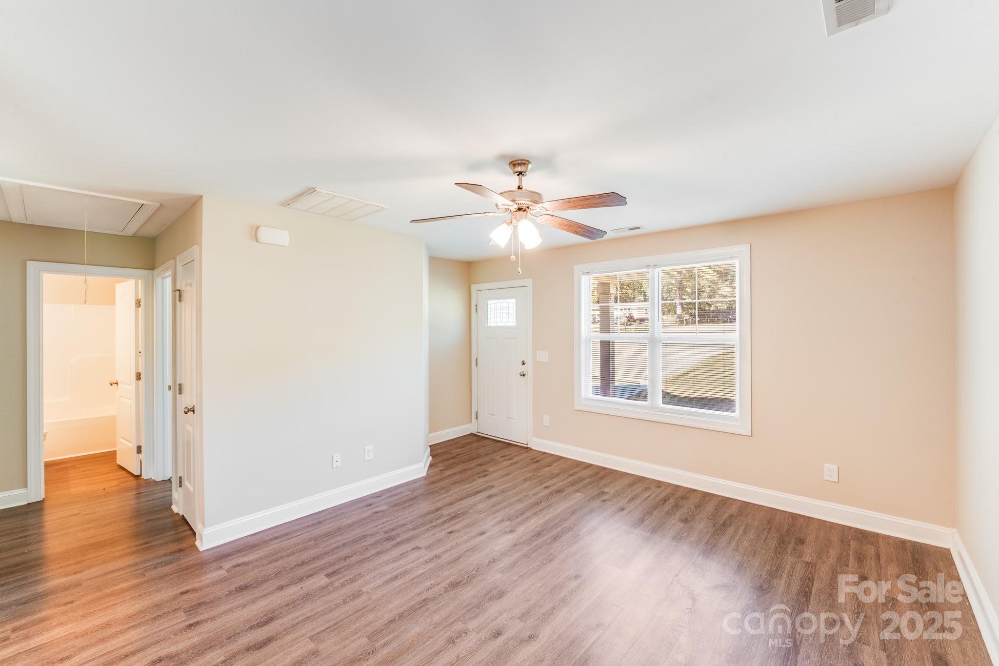 3133 Roberta Road Concord, NC 28027 - Photo 11 of 22 a view of an empty room with a window and wooden floor
