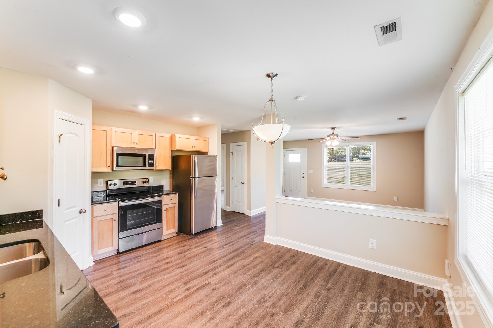 3133 Roberta Road Concord, NC 28027 - Photo 12 of 22 a kitchen with stainless steel appliances kitchen island granite countertop a refrigerator and a stove top oven
