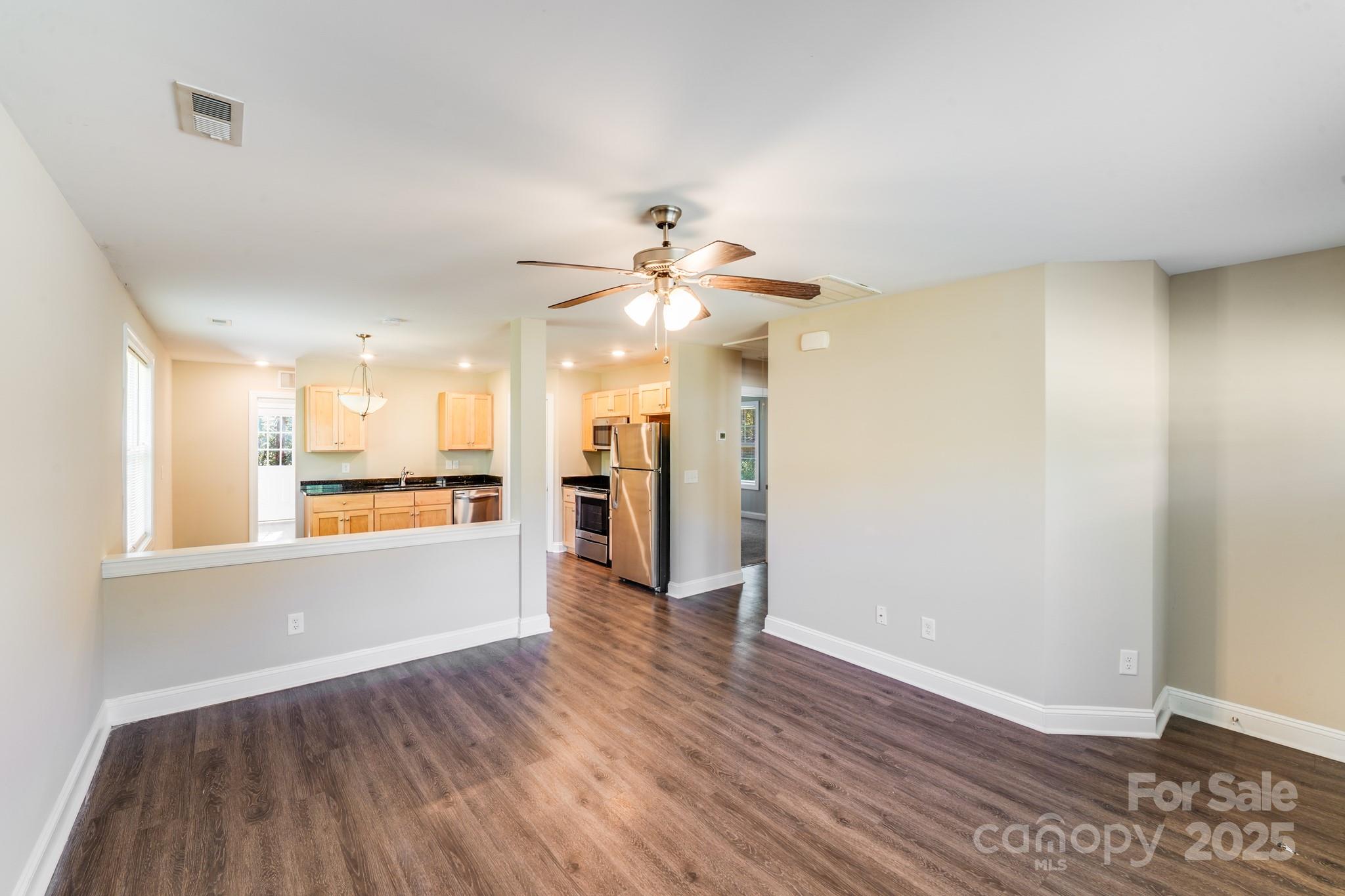 3133 Roberta Road Concord, NC 28027 - Photo 2 of 22 a view of an empty room with window and wooden floor