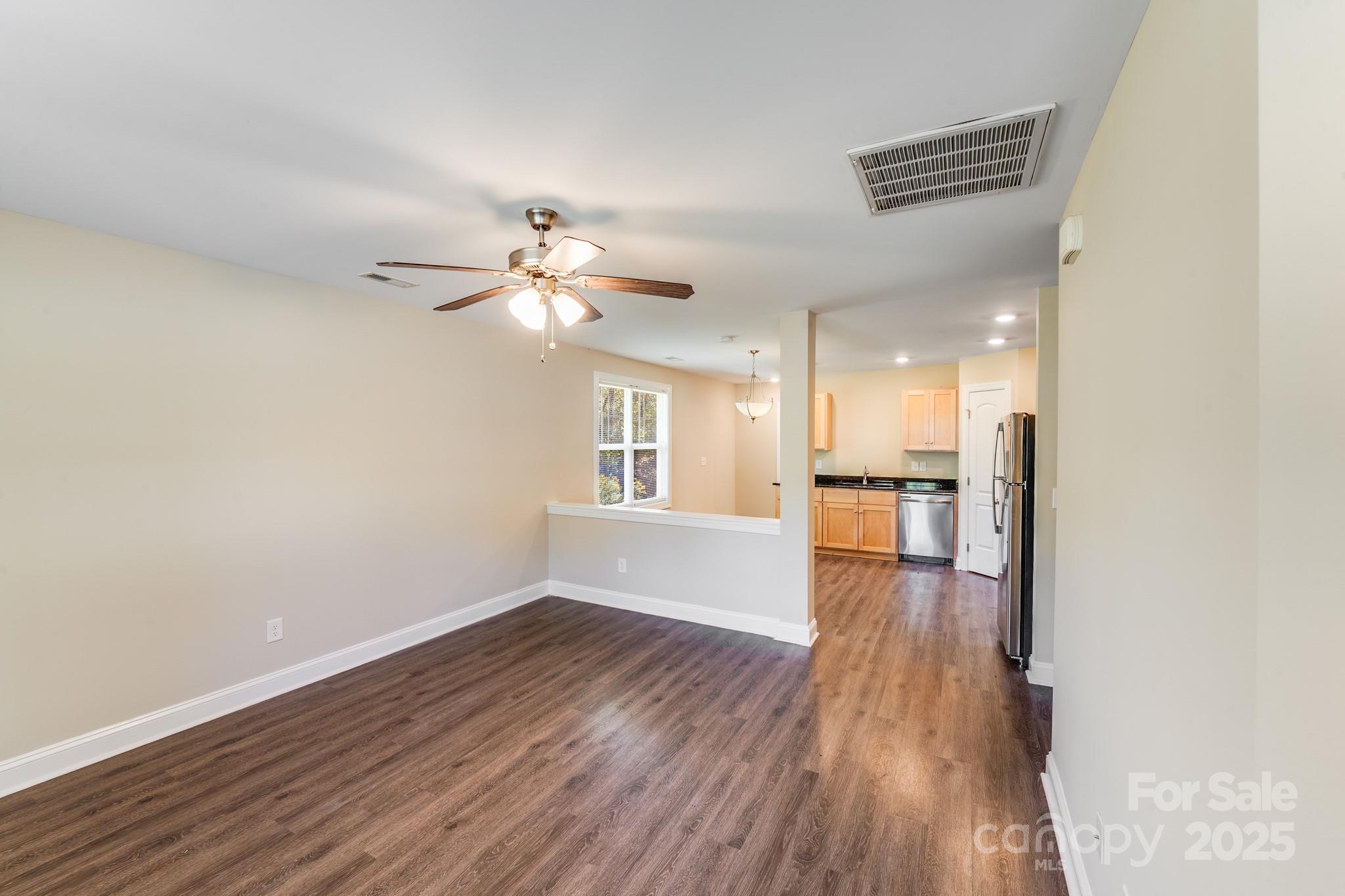 3133 Roberta Road Concord, NC 28027 - Photo 7 of 22 a view of an empty room with wooden floor and a window