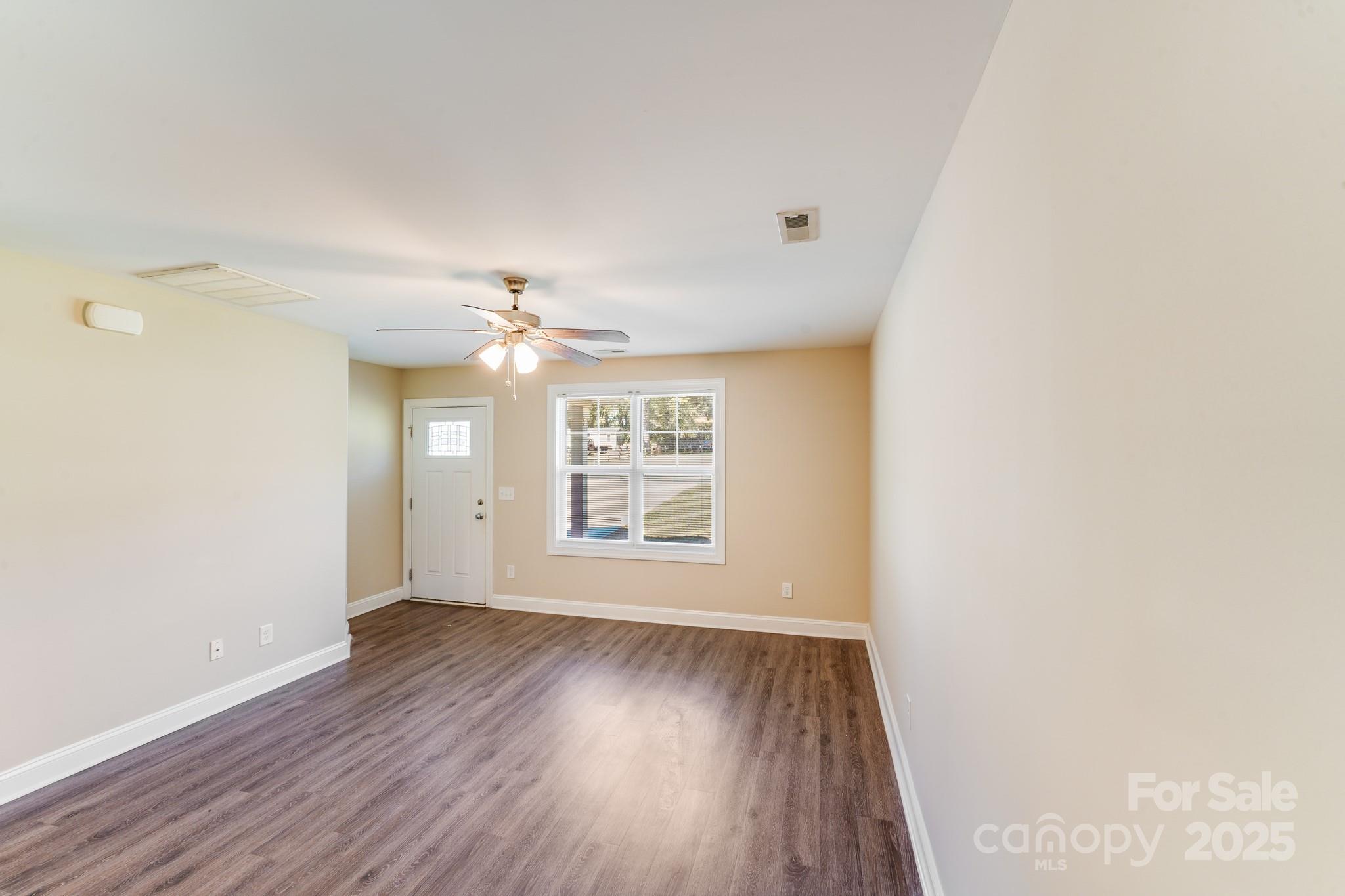 3133 Roberta Road Concord, NC 28027 - Photo 9 of 22 wooden floor in an empty room with a window