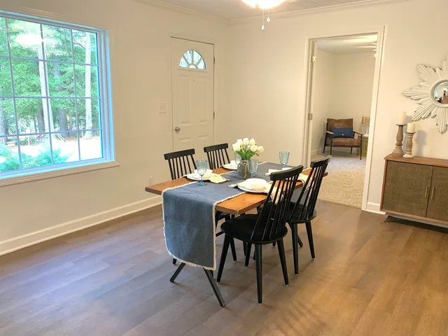 a dining room with furniture and wooden floor