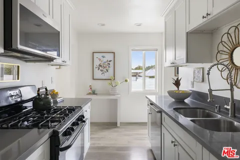 a kitchen that has a sink and a stove