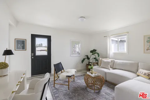 a living room with furniture a couch and a window