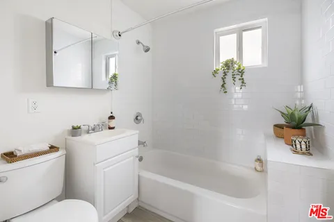 a white bath tub sitting next to a white toilet