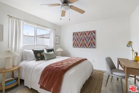 a bedroom with a bed and a desk