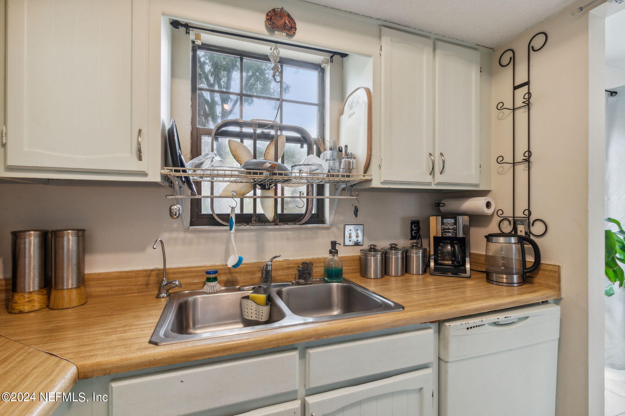 1004 Kettering Way Orange Park, FL 32073 - Photo 11 of 29 a kitchen with stainless steel appliances granite countertop a sink a stove and a wooden cabinets