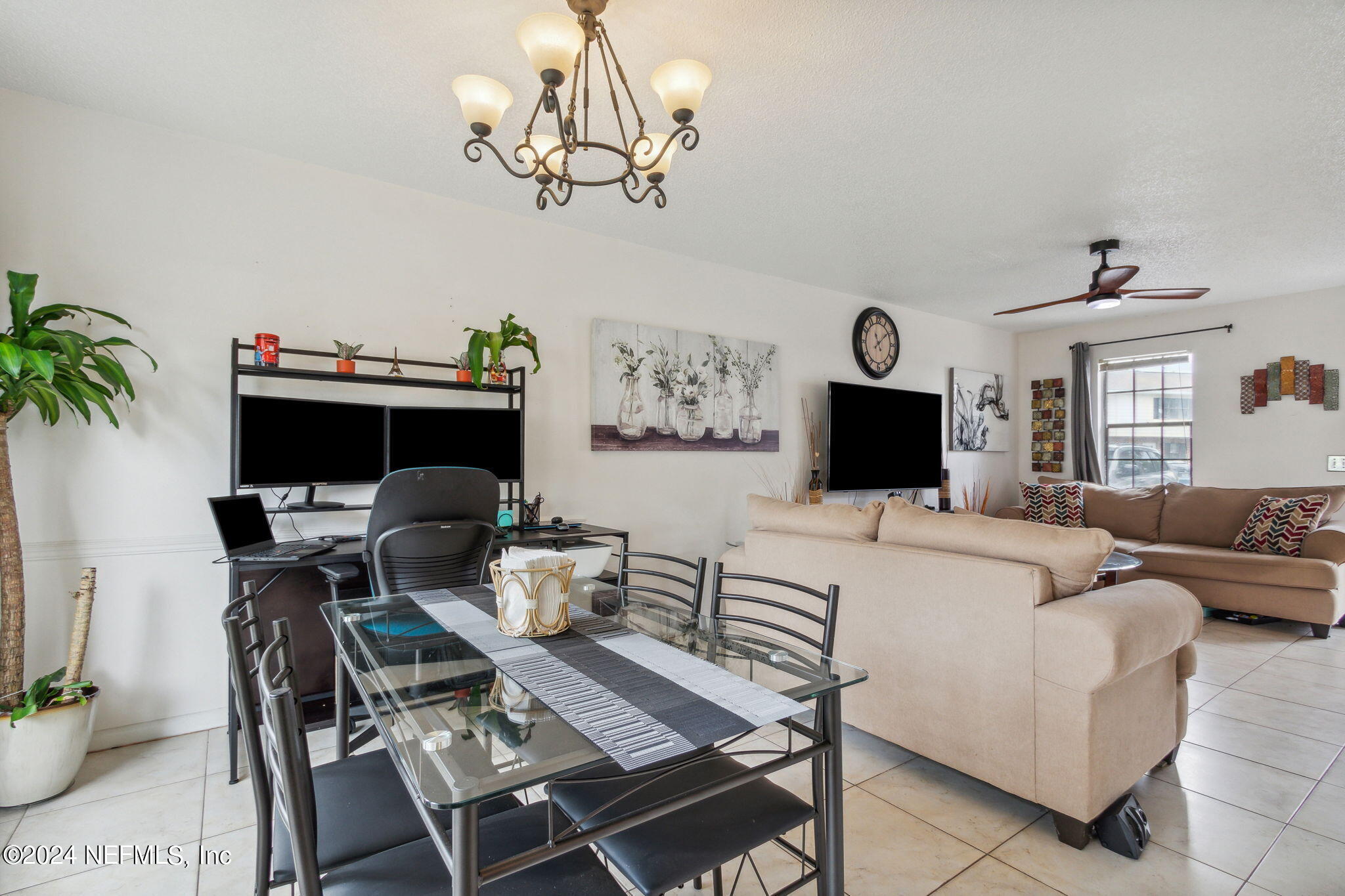 1004 Kettering Way Orange Park, FL 32073 - Photo 12 of 29 a living room with furniture a flat screen tv and a chandelier